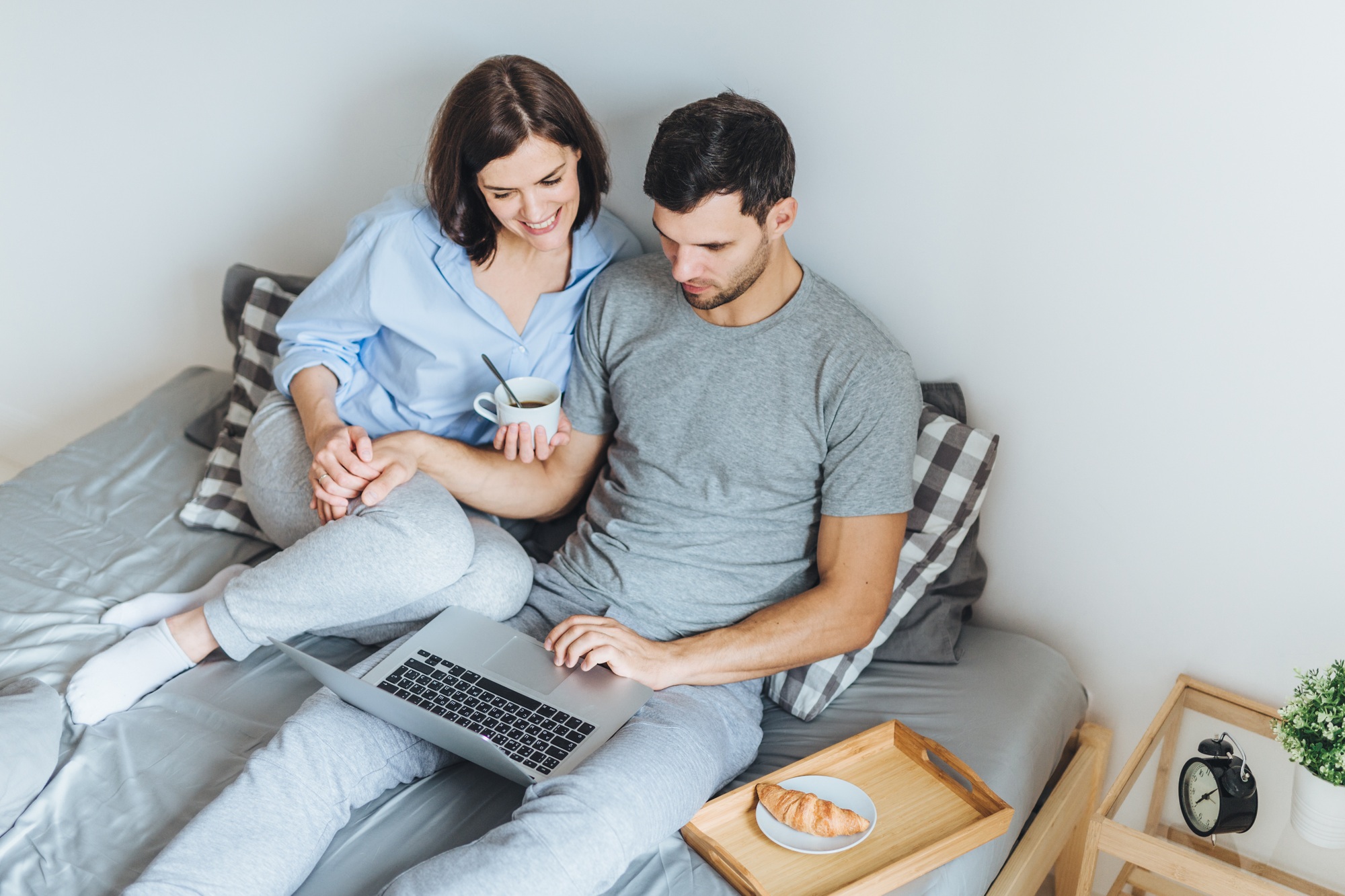 Wife and husband make shopping online, choose present for their little child in internet